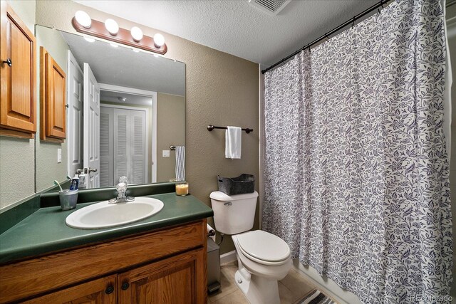 23712 Pondview Pl Unit A, Golden, CO 80401 - full bathroom with a textured wall, vanity, a textured ceiling, tile patterned floors, and curtained shower