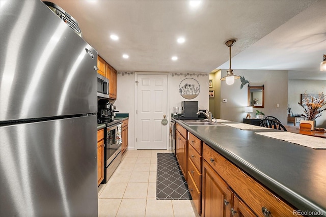 23712 Pondview Pl Unit A, Golden, CO 80401 - kitchen featuring appliances with stainless steel finishes, brown cabinetry, dark countertops, light tile patterned floors, and recessed lighting