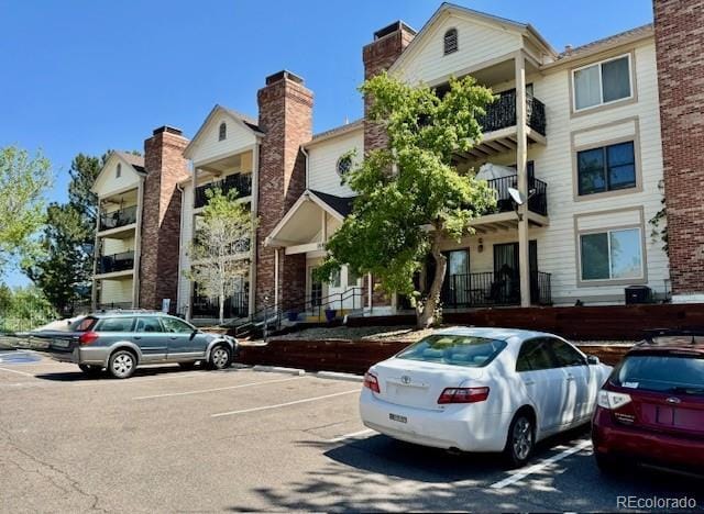 view of property featuring uncovered parking