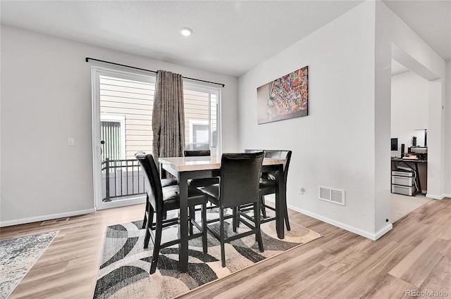 dining area featuring visible vents, baseboards, and light wood-style floors