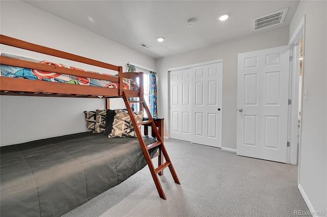 carpeted bedroom with a closet, visible vents, recessed lighting, and baseboards