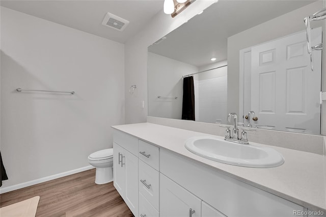 full bath featuring visible vents, baseboards, toilet, wood finished floors, and vanity