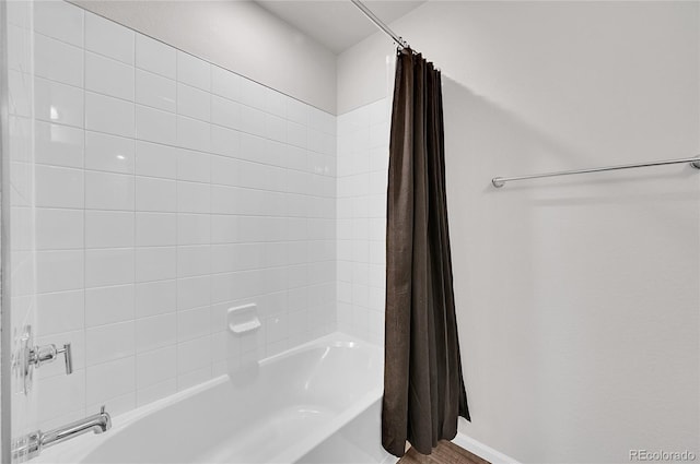 bathroom featuring shower / bath combination with curtain and baseboards