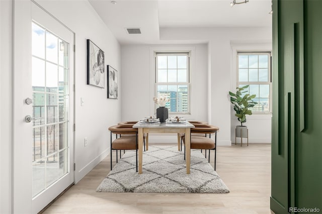 office area with a healthy amount of sunlight and light hardwood / wood-style flooring