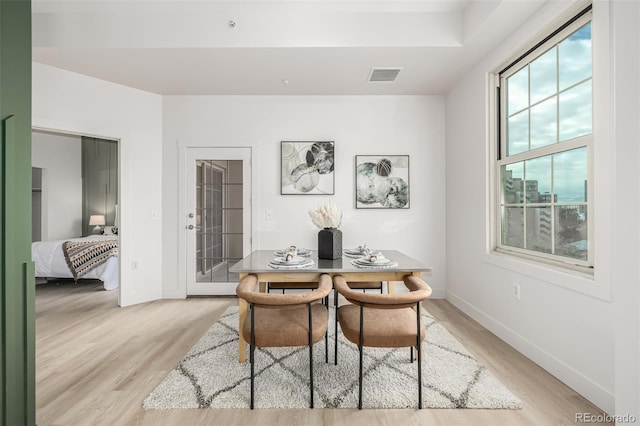 dining space featuring light wood-type flooring