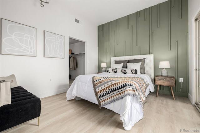 bedroom with a closet and light wood-type flooring