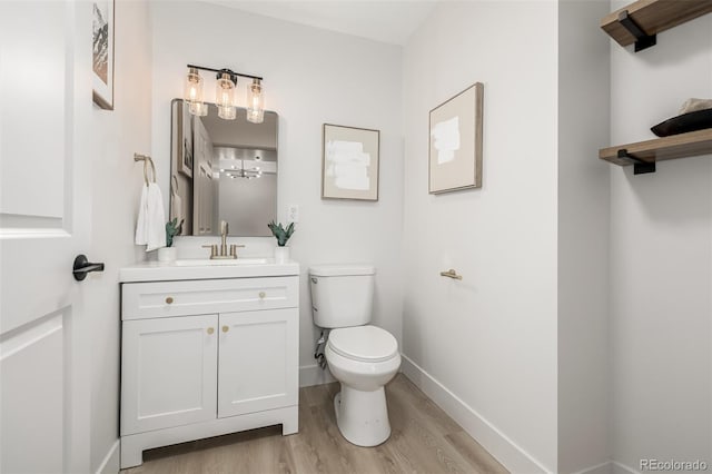 bathroom featuring hardwood / wood-style floors, vanity, and toilet