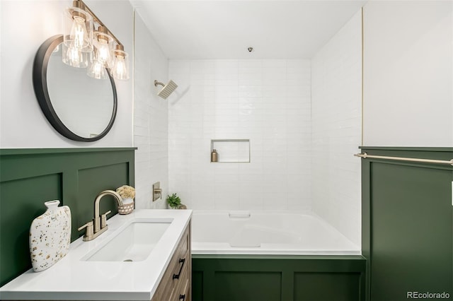 bathroom featuring vanity and tiled shower / bath combo