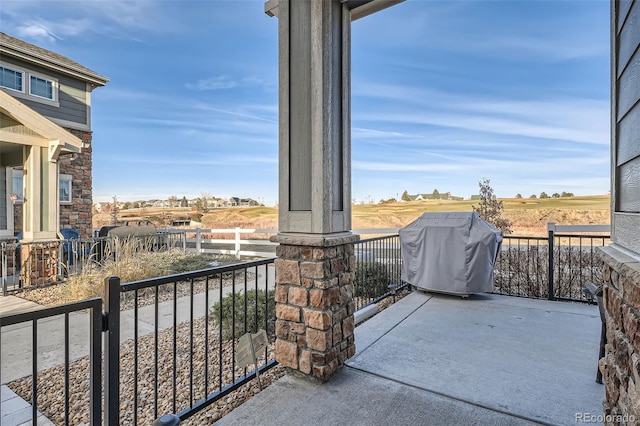 balcony with a rural view and a grill