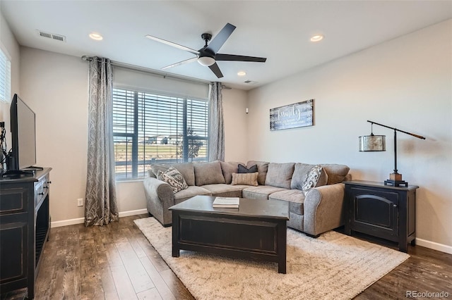 living room with dark hardwood / wood-style floors and ceiling fan