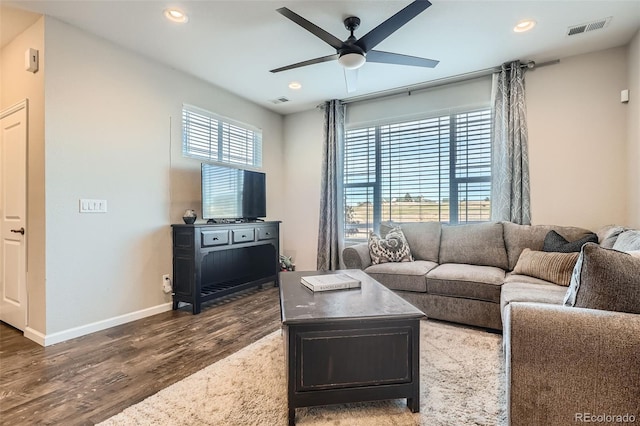 living room with ceiling fan and dark hardwood / wood-style floors