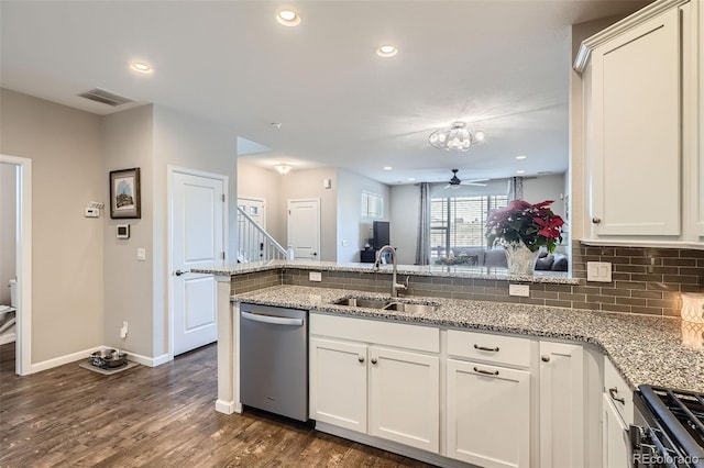 kitchen with sink, stainless steel appliances, dark hardwood / wood-style flooring, kitchen peninsula, and white cabinets