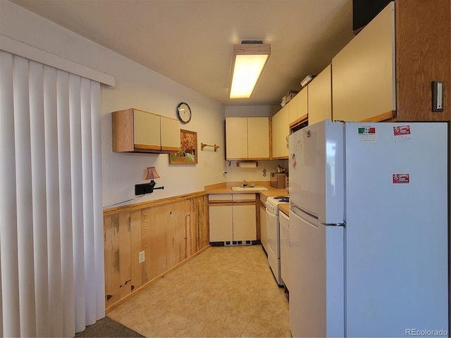 kitchen featuring white appliances and sink