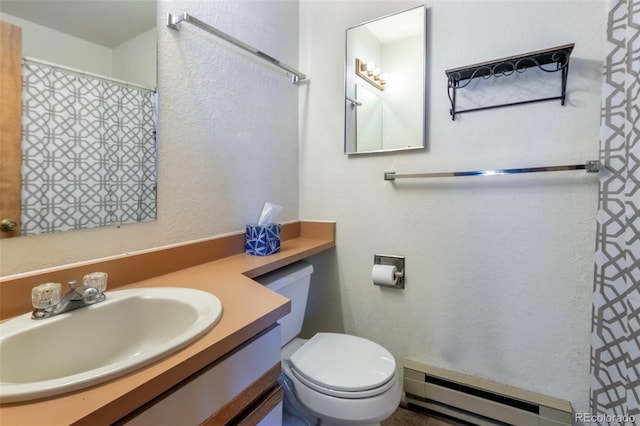 bathroom featuring toilet, vanity, and a baseboard heating unit