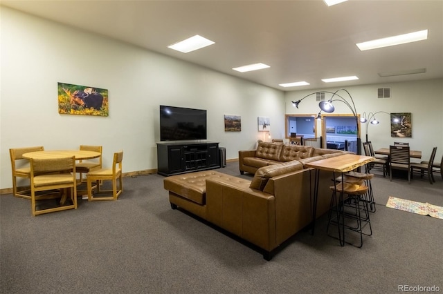 living room with dark colored carpet