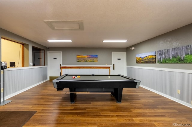 playroom with wood-type flooring, a textured ceiling, and pool table