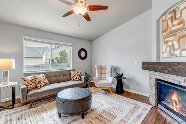 2132 Boise Ct, Longmont, CO 80504 - living area featuring wood finished floors, ceiling fan, baseboards, and a stone fireplace