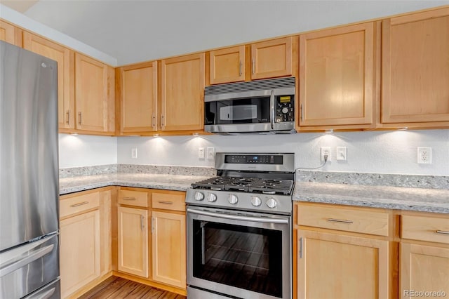 2132 Boise Ct, Longmont, CO 80504 - kitchen with appliances with stainless steel finishes, light brown cabinets, light wood finished floors, and light stone countertops