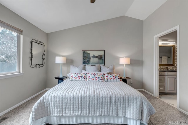 2132 Boise Ct, Longmont, CO 80504 - carpeted bedroom with vaulted ceiling, baseboards, ensuite bath, and a sink