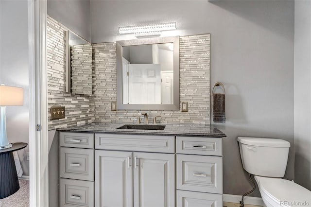 2132 Boise Ct, Longmont, CO 80504 - bathroom featuring toilet, backsplash, vanity, and baseboards