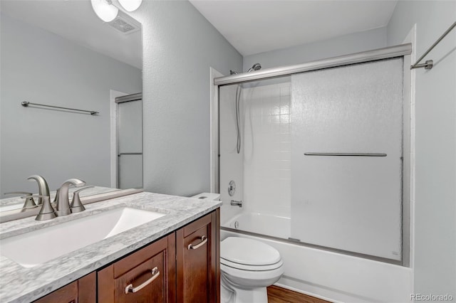 2132 Boise Ct, Longmont, CO 80504 - full bath with toilet, vanity, combined bath / shower with glass door, and wood finished floors