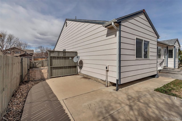 2132 Boise Ct, Longmont, CO 80504 - view of home's exterior featuring fence, a gate, a patio area, and entry steps
