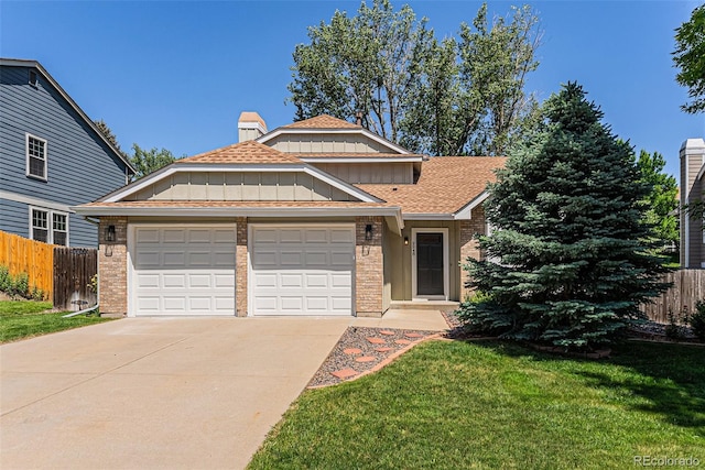 9948 King St, Westminster, CO 80031 - view of front of house with an attached garage, concrete driveway, brick siding, and board and batten siding