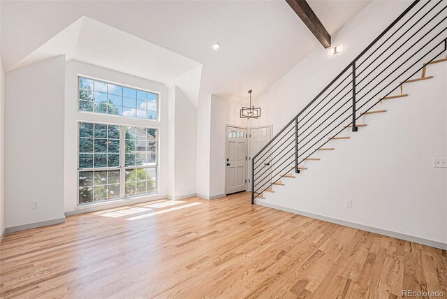 9948 King St, Westminster, CO 80031 - foyer with stairs, a chandelier, light wood-style flooring, high vaulted ceiling, and beamed ceiling