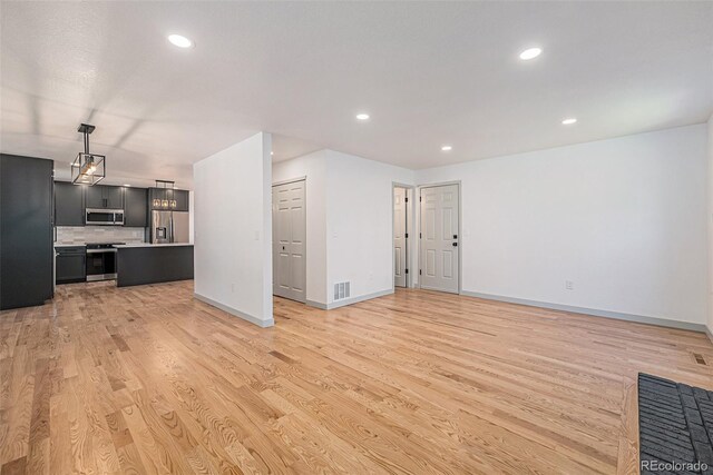 9948 King St, Westminster, CO 80031 - unfurnished living room featuring light wood-style floors and recessed lighting