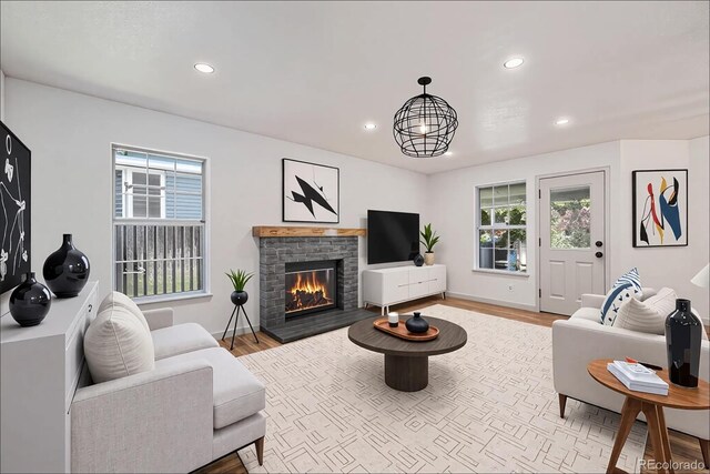 9948 King St, Westminster, CO 80031 - living area with recessed lighting, a stone fireplace, and wood finished floors