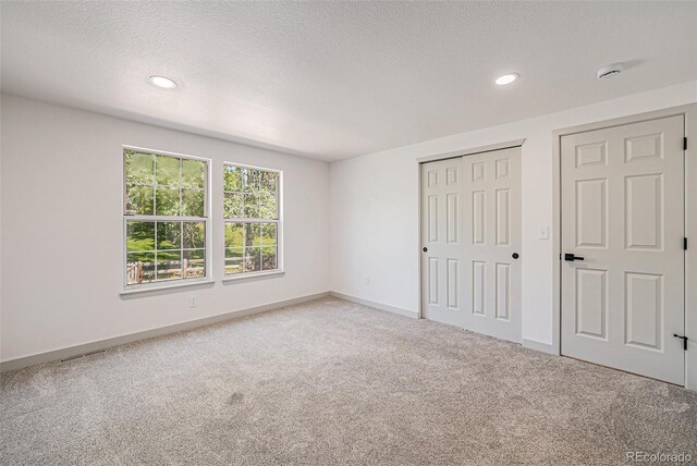 9948 King St, Westminster, CO 80031 - unfurnished bedroom featuring carpet, a textured ceiling, recessed lighting, and a closet