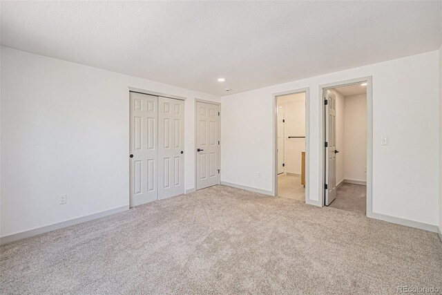 9948 King St, Westminster, CO 80031 - unfurnished bedroom featuring light colored carpet, recessed lighting, a closet, and connected bathroom