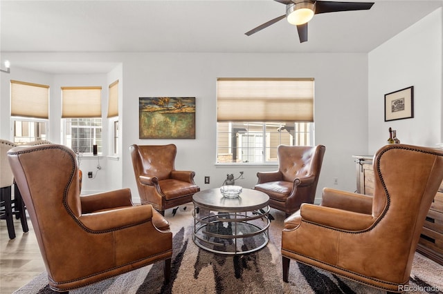 sitting room featuring ceiling fan and light wood-type flooring