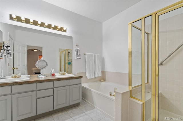 bathroom featuring vanity and shower with separate bathtub