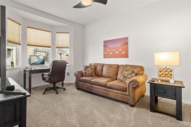 carpeted home office with ceiling fan