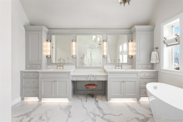 bathroom with lofted ceiling, a freestanding tub, marble finish floor, and vanity