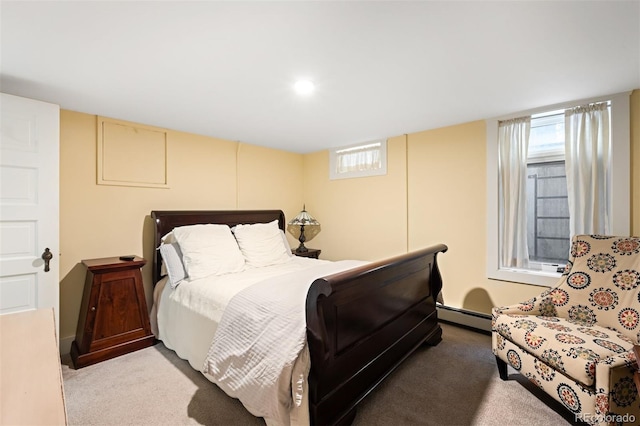 carpeted bedroom with a baseboard radiator