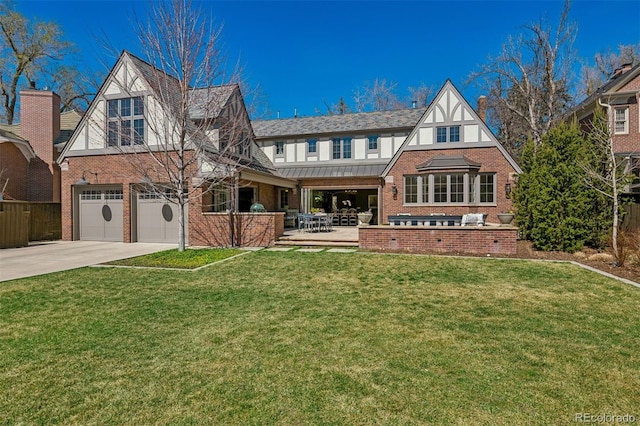 exterior space featuring driveway, brick siding, fence, an attached garage, and a front lawn