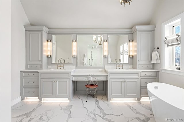 bathroom featuring an inviting chandelier, marble finish floor, and vanity