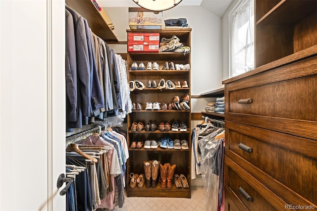 walk in closet featuring vaulted ceiling