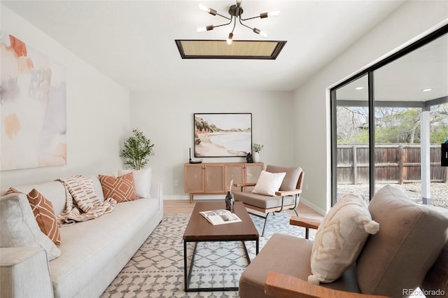 4682 Chatham St, Boulder, CO 80301 - living room featuring a chandelier, light wood-type flooring, and baseboards