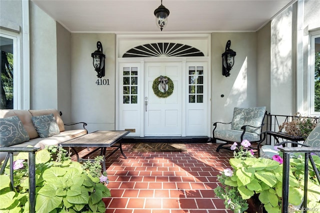 view of exterior entry with covered porch