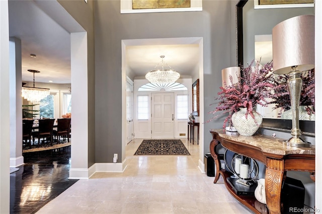 tiled foyer featuring a chandelier