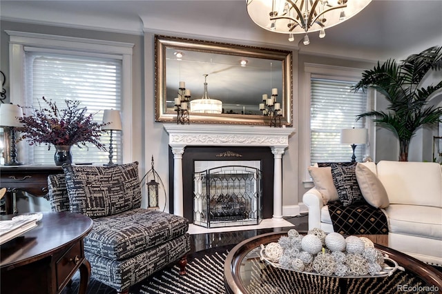 sitting room featuring ornate columns and crown molding