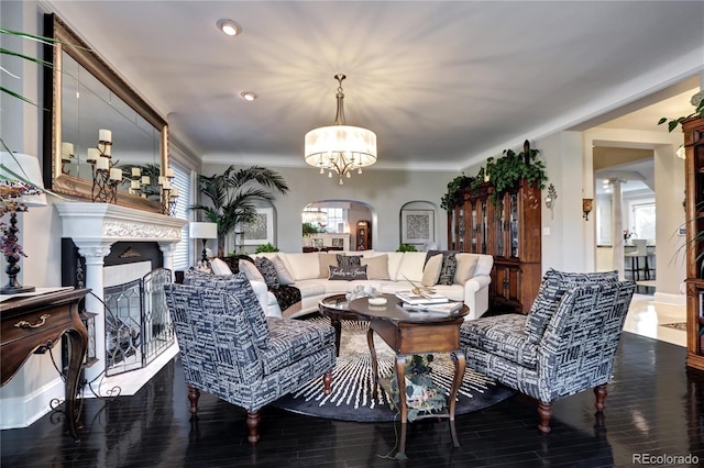 living room with a chandelier and dark wood-type flooring