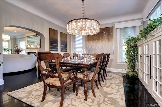 dining area with a healthy amount of sunlight, a chandelier, and hardwood / wood-style floors