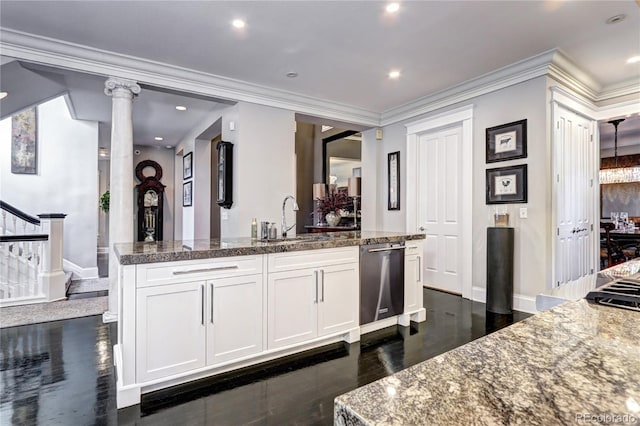 kitchen with sink, ornate columns, stainless steel dishwasher, white cabinets, and crown molding