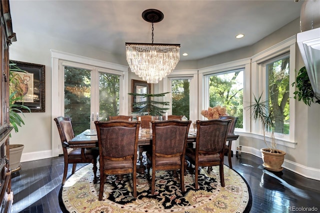 dining area featuring a notable chandelier and dark hardwood / wood-style flooring