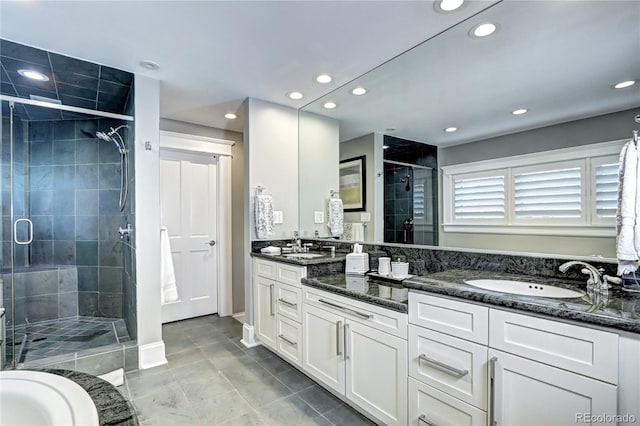 bathroom with vanity, tile patterned flooring, and a shower with door