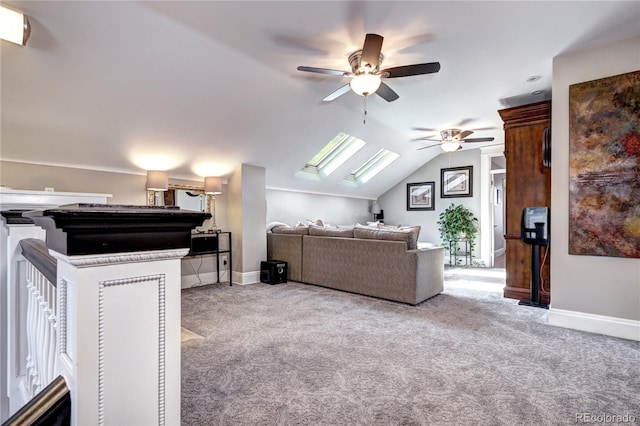 carpeted living room featuring lofted ceiling with skylight, a healthy amount of sunlight, and ceiling fan